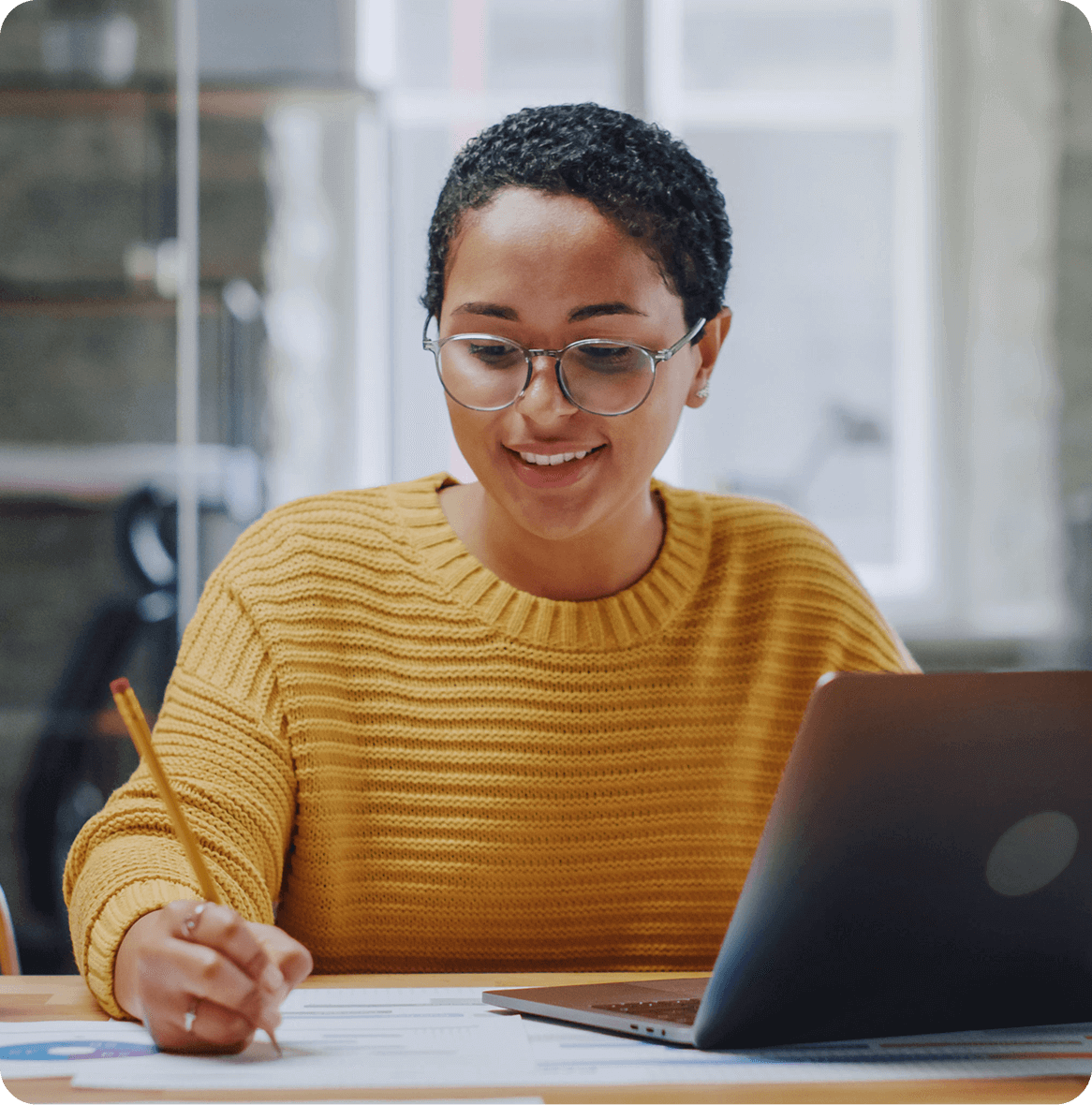 Girl in yellow sleeve holding a pencil