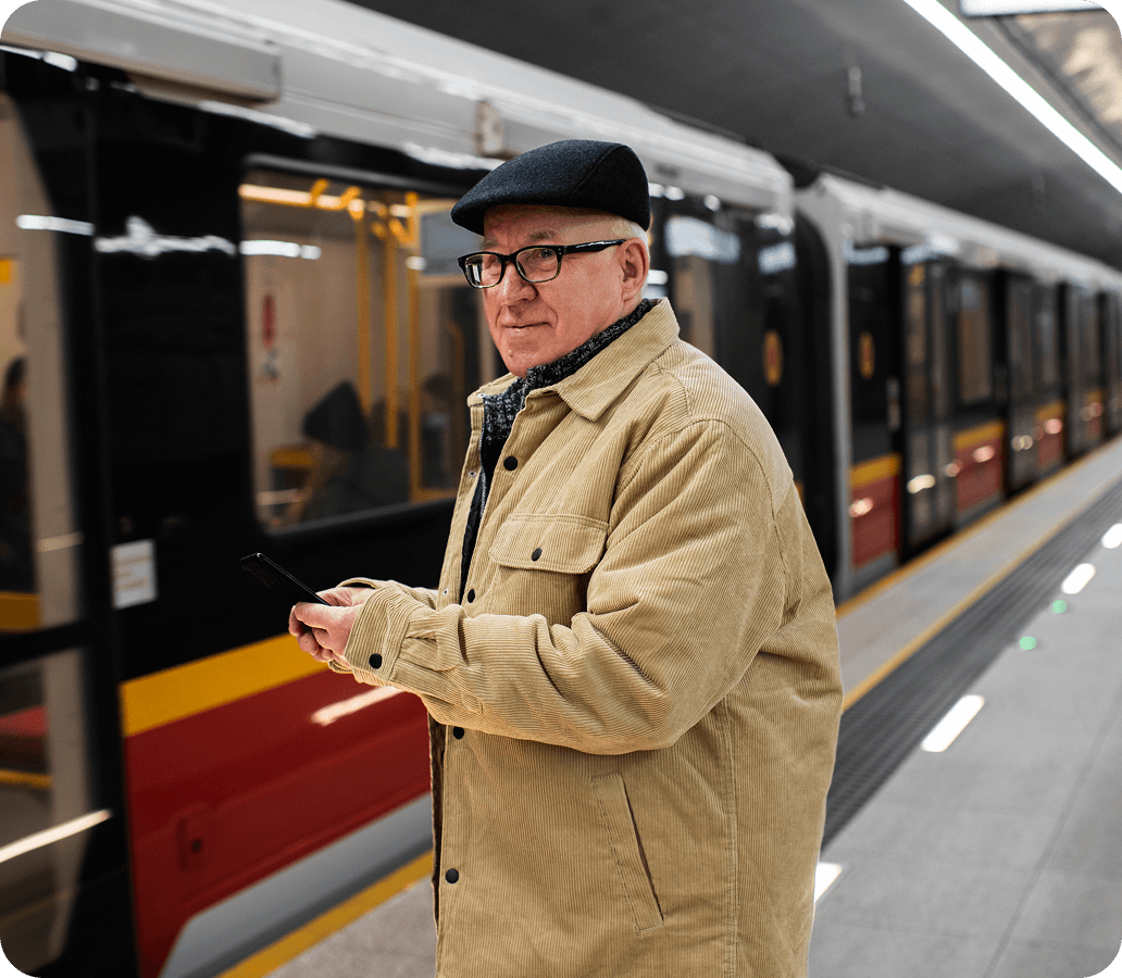man in beige jacket in train station